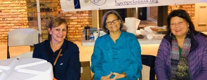 Hope Church women serving hot chocolate and cookies at the Opelousas Christmas Parade